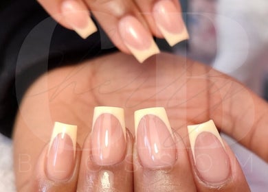 Close-up of elegant French manicure at Cherry Blossom, Gönyeli, TR, showcasing glossy finish.