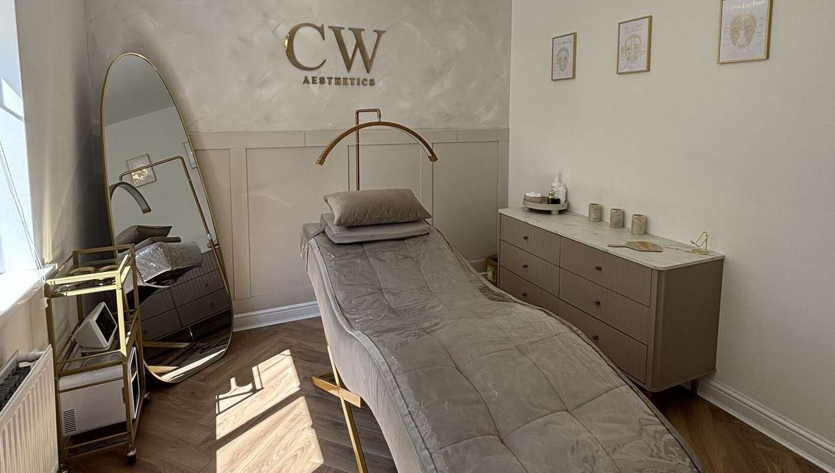 Luxurious treatment room at Cw Aesthetics in Bryncethin, Wales, GB featuring a plush bed and elegant decor.