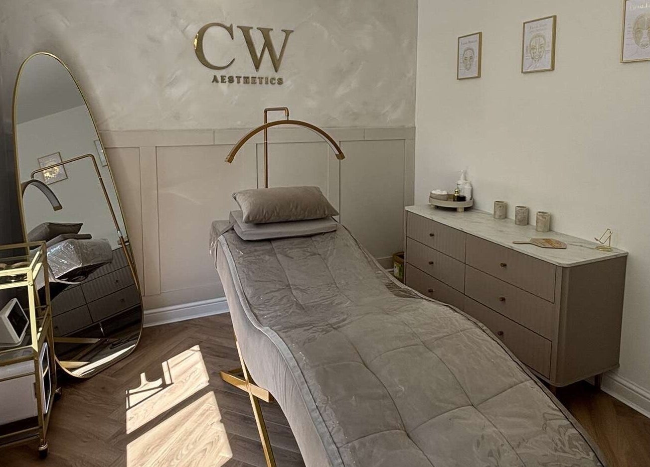 Luxurious treatment room at Cw Aesthetics in Bryncethin, Wales, GB featuring a plush bed and elegant decor.