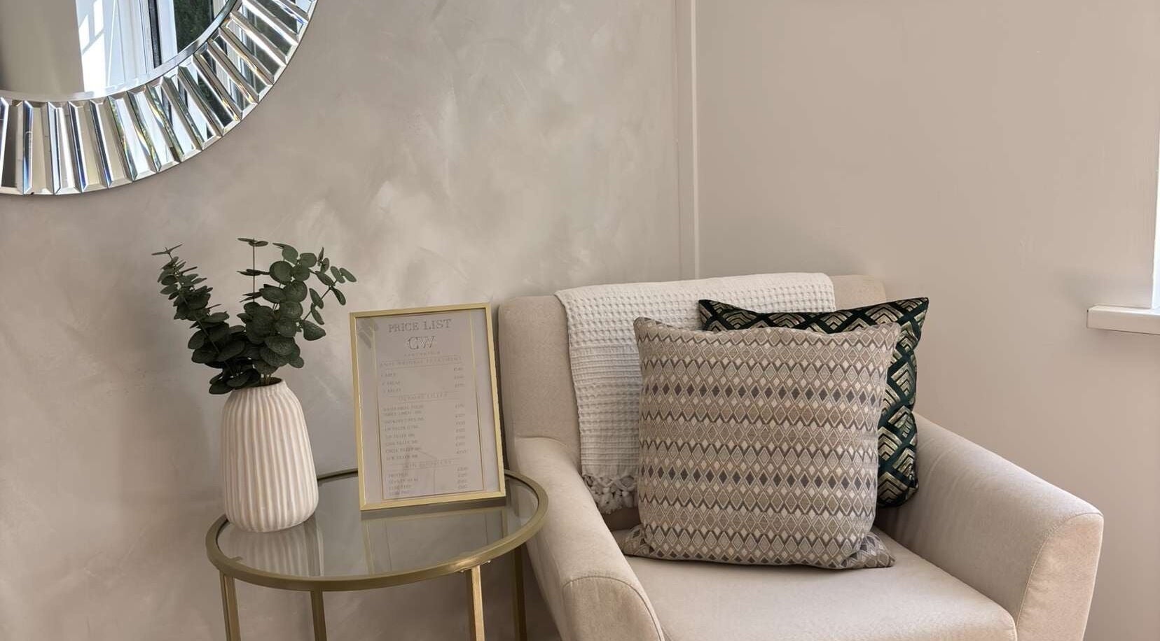 Comfortable seating with tasteful decor at Cw Aesthetics, Bryncethin, Wales, GB, highlighting a tranquil ambiance.