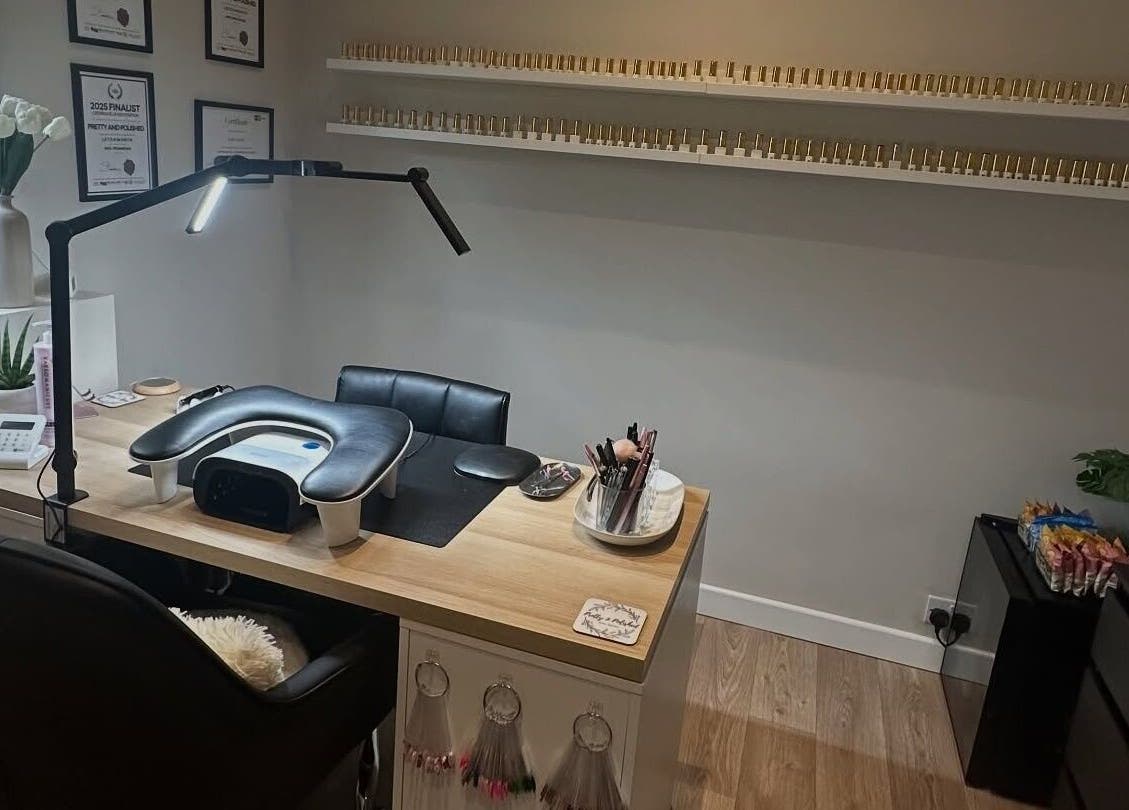 Modern nail desk at Pretty and Polished in Sandy, England, GB, showcasing tools and decor.