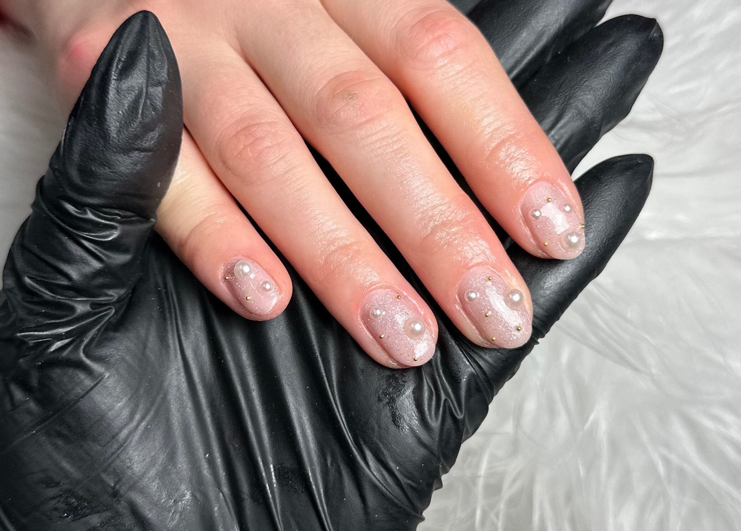 Elegant pearl-accented manicure at Pretty and Polished in Sandy, England, GB.