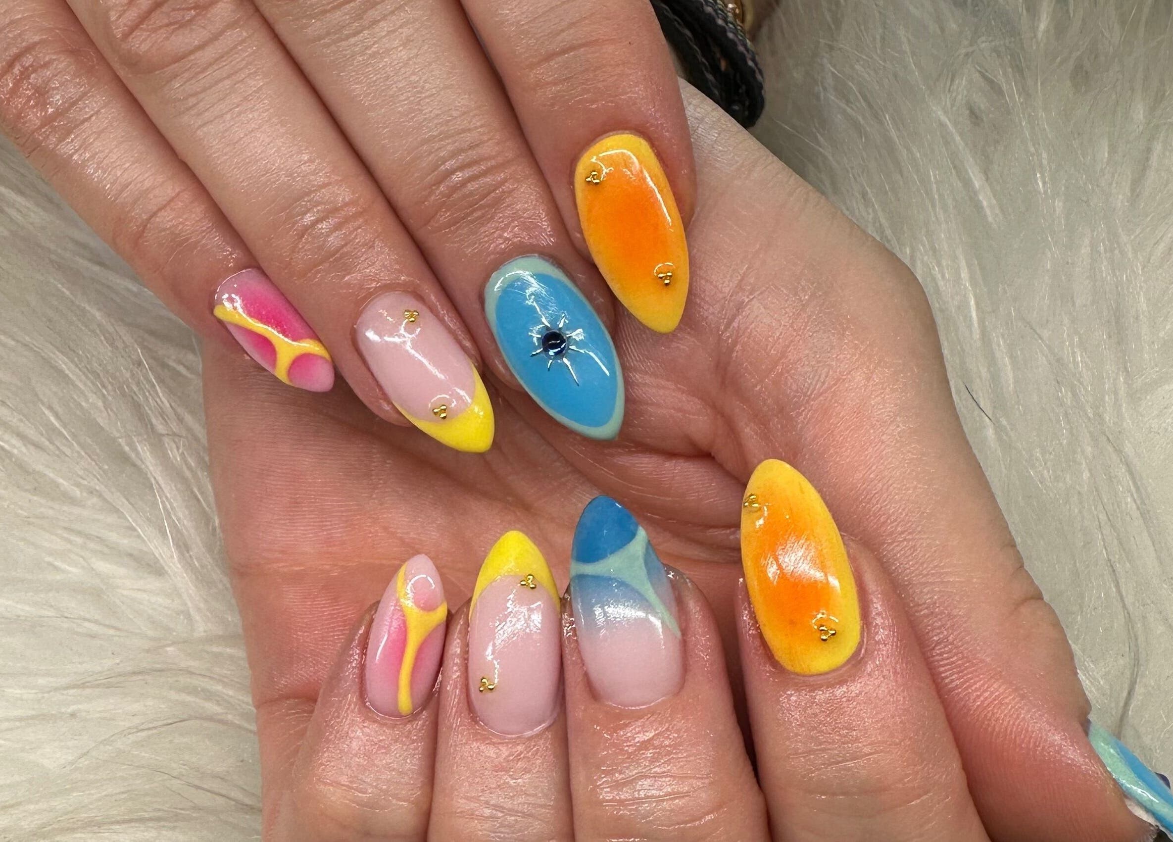 Bright nail art featuring colorful designs at Pretty and Polished, Sandy, England, GB.
