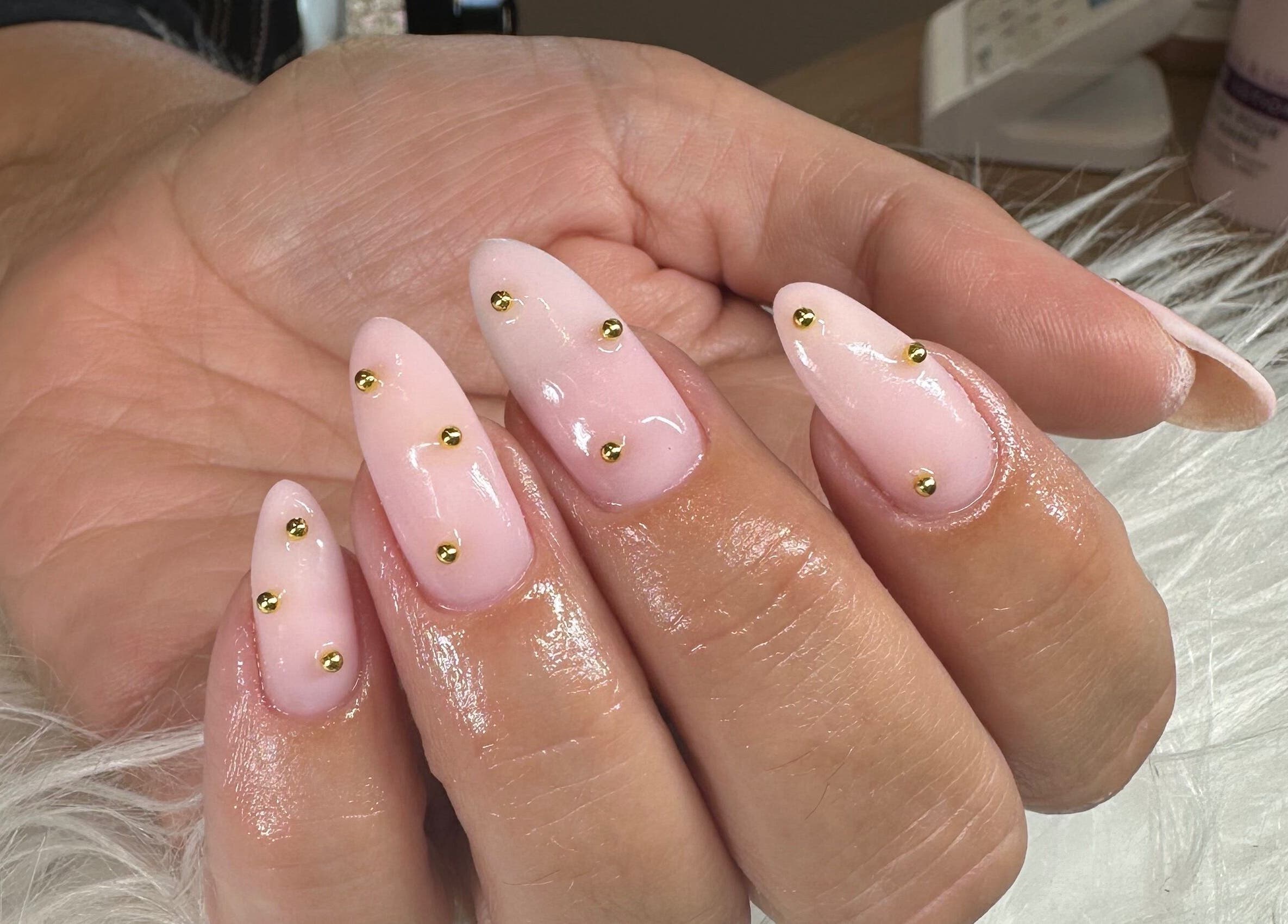 Elegant pink nails with gold accents at Pretty and Polished in Sandy, England, GB.