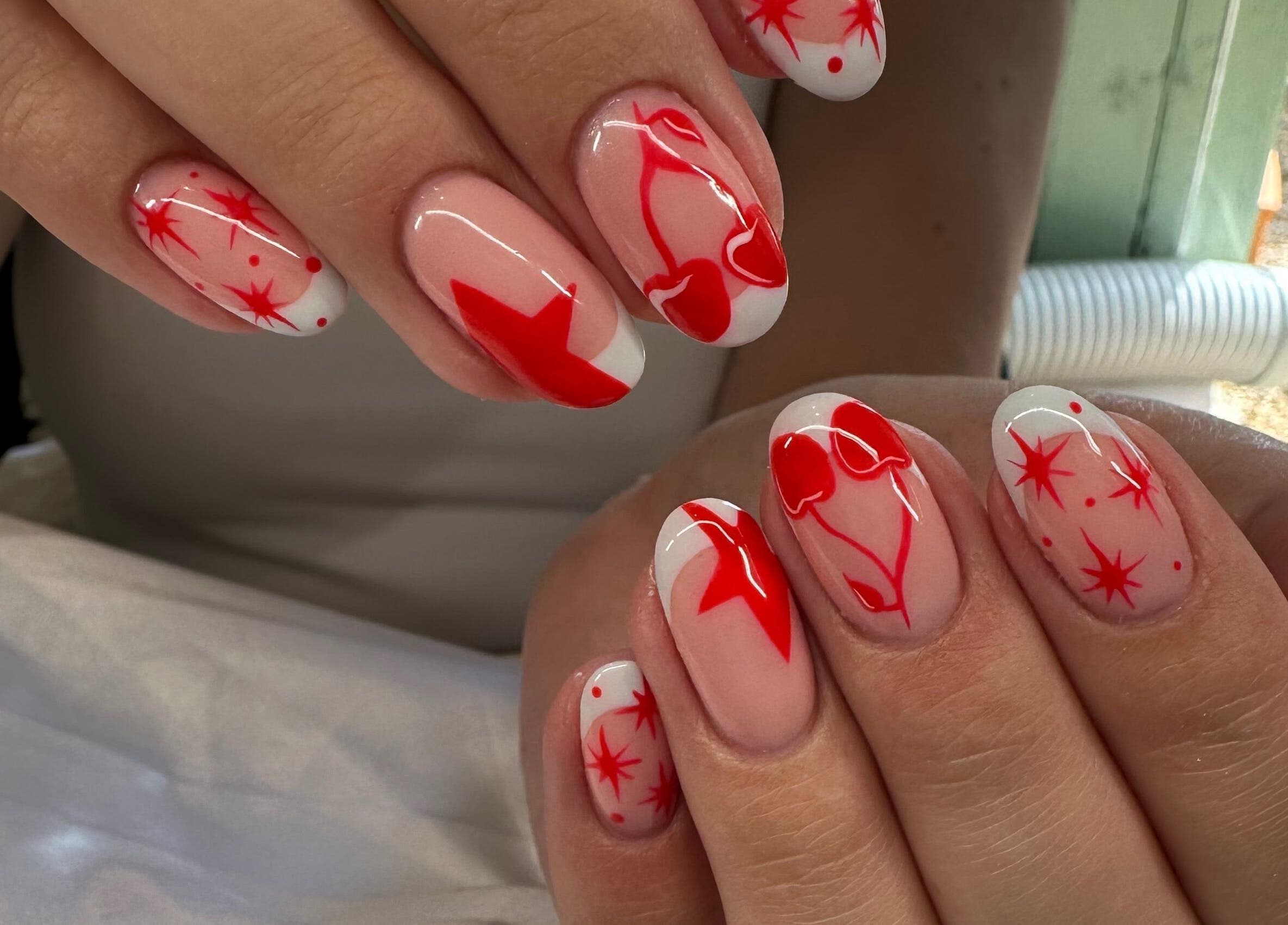 Red and white star nail art at Pretty and Polished, Sandy, England, GB.