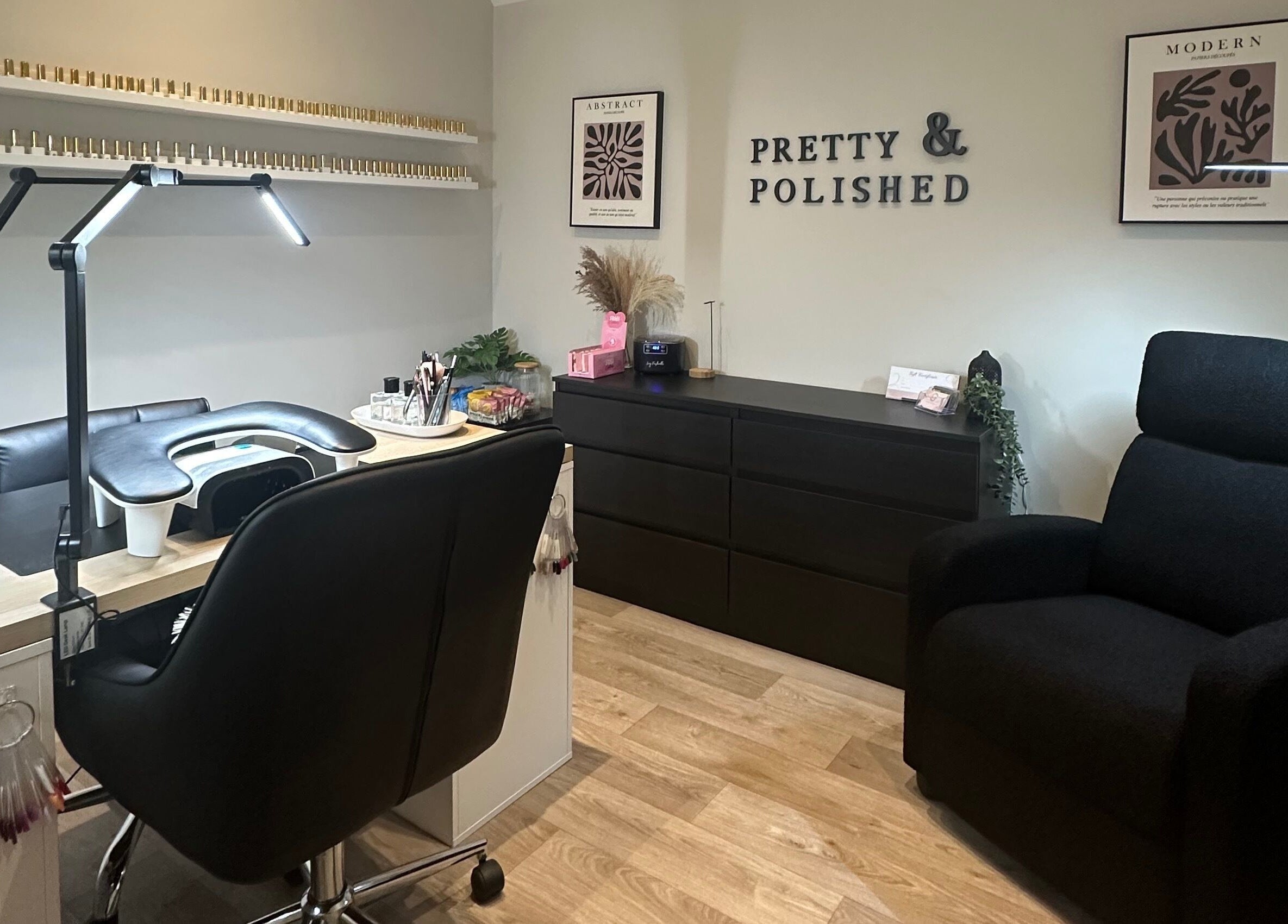 Pretty and Polished's cozy nail salon in Sandy, England, GB showcases elegant workstation and plush seating.