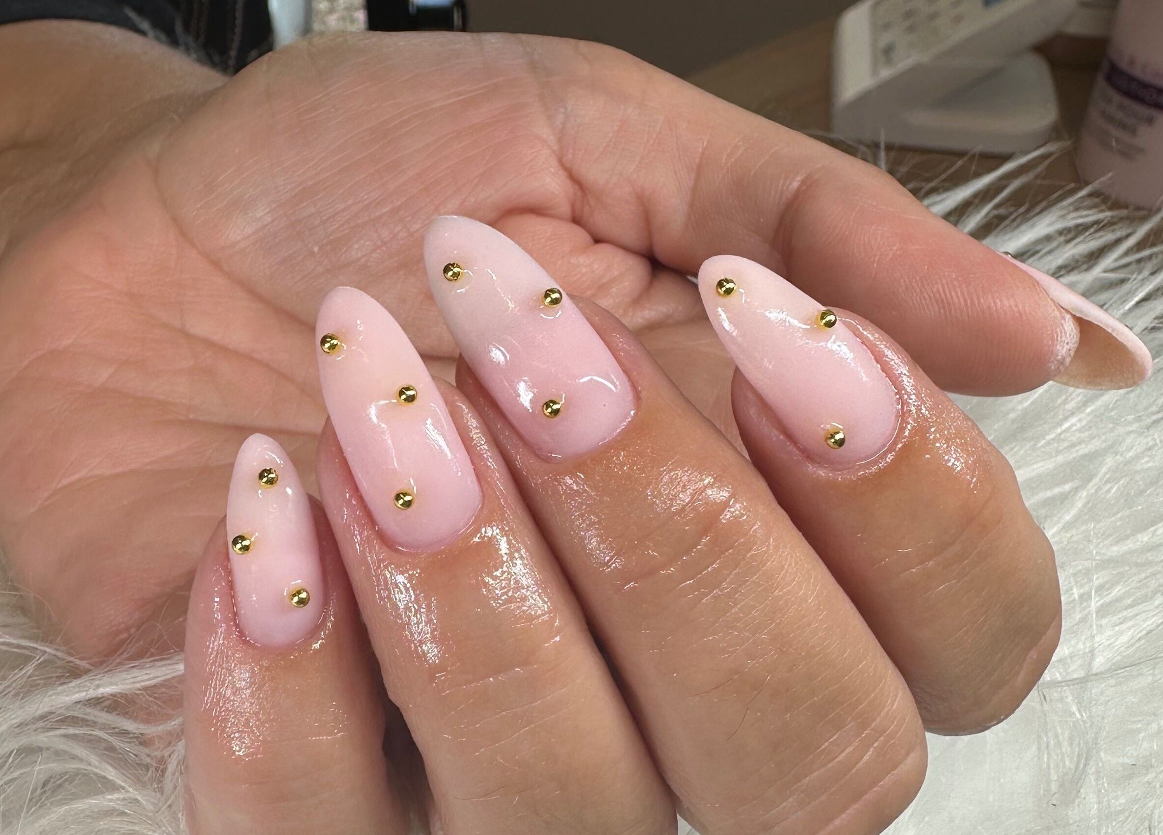 Elegant gold-studded nails at Pretty and Polished, Sandy, England, GB. Nail design showcases intricate detailing.