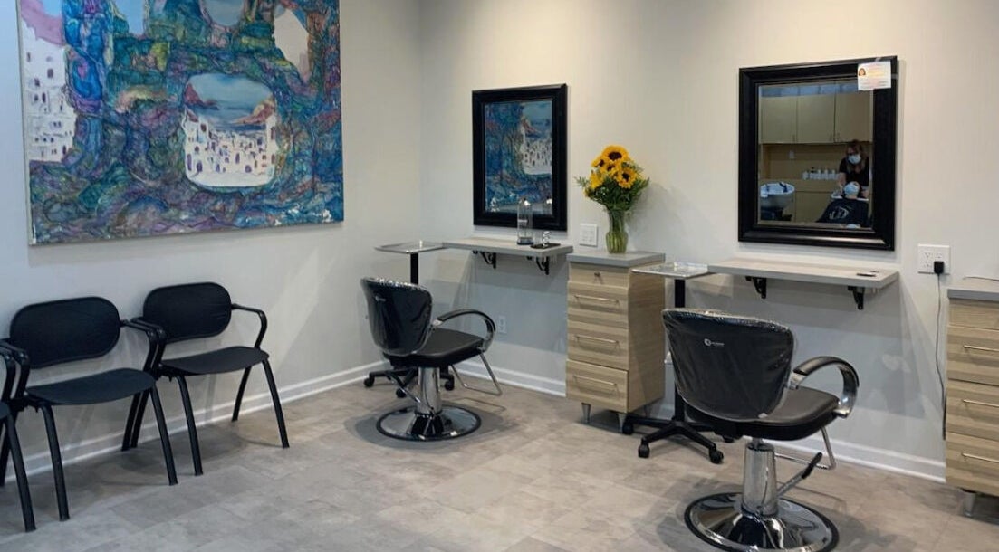 Modern interior of Gemini Hair Studio in Randolph, New Jersey with stylish chairs and wall art.