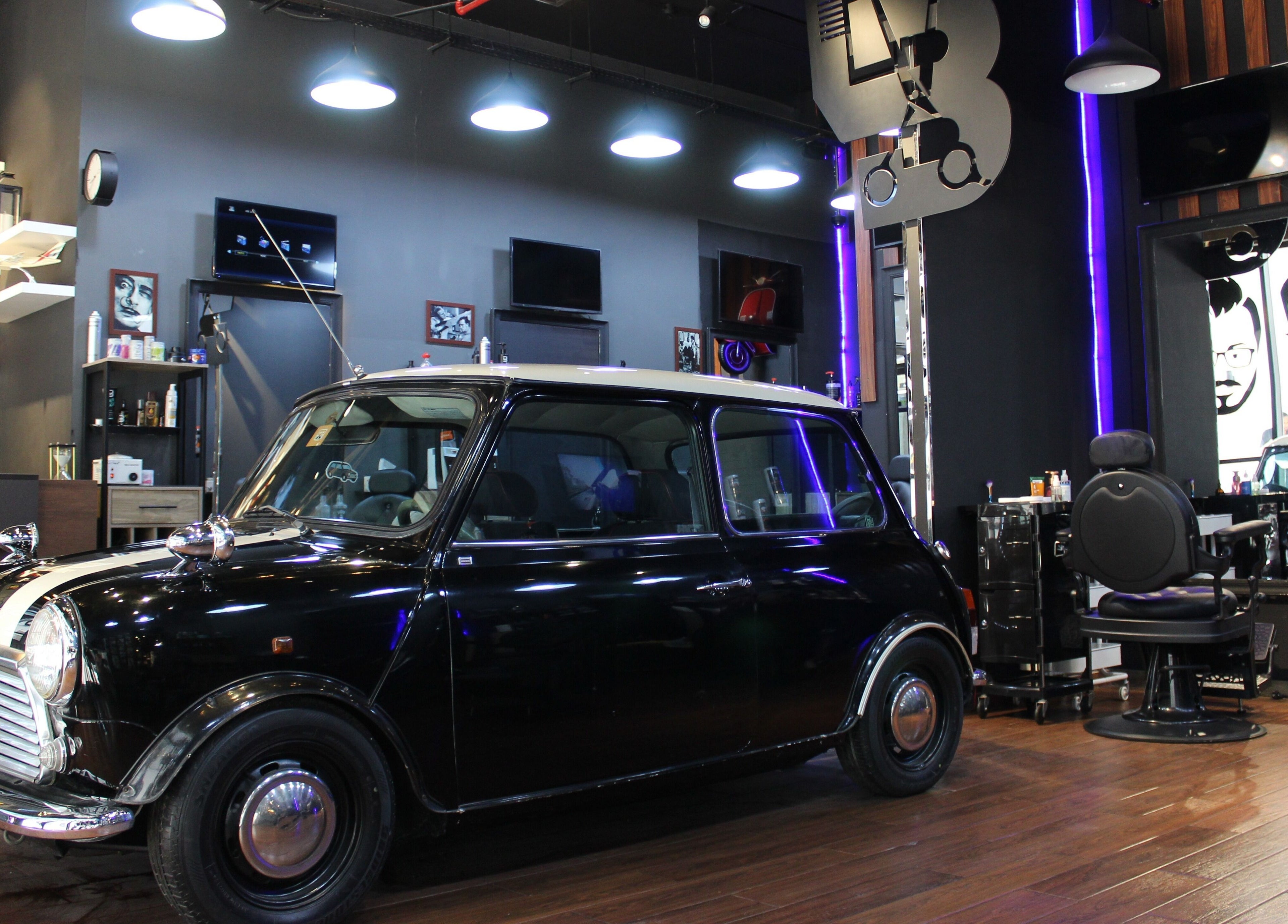 Stylish interior at Black Level Gent's Salon, Dubai, Dubai, AE featuring a classic car and modern decor.