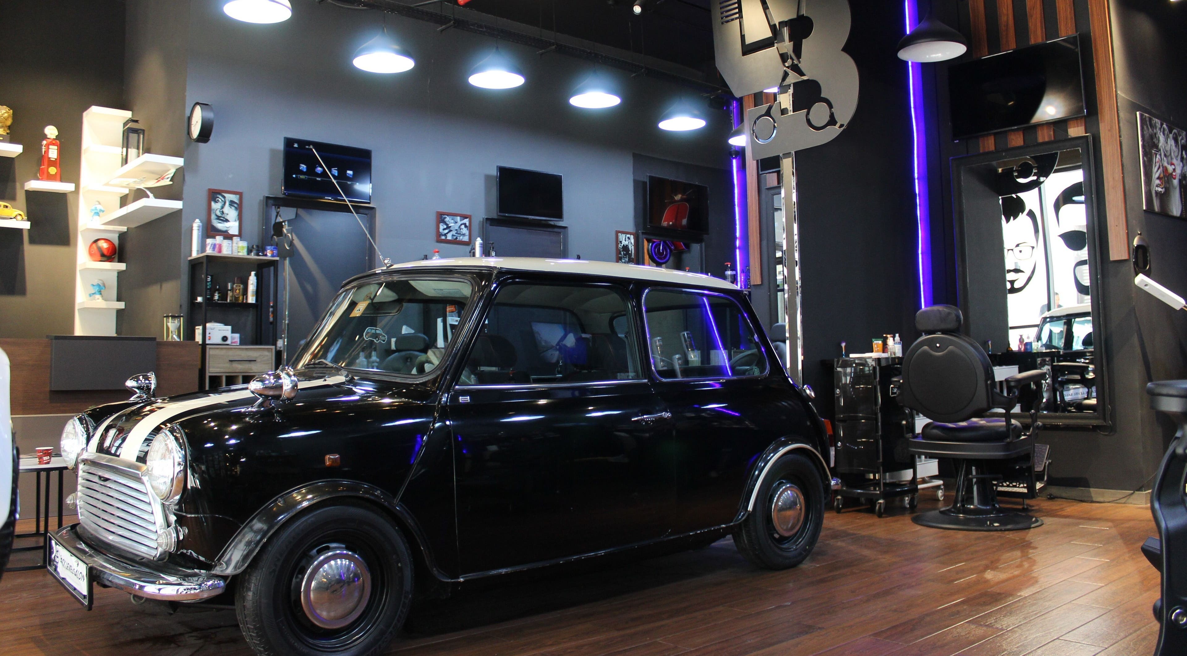 Stylish interior at Black Level Gent's Salon, Dubai, Dubai, AE featuring a classic car and modern decor.
