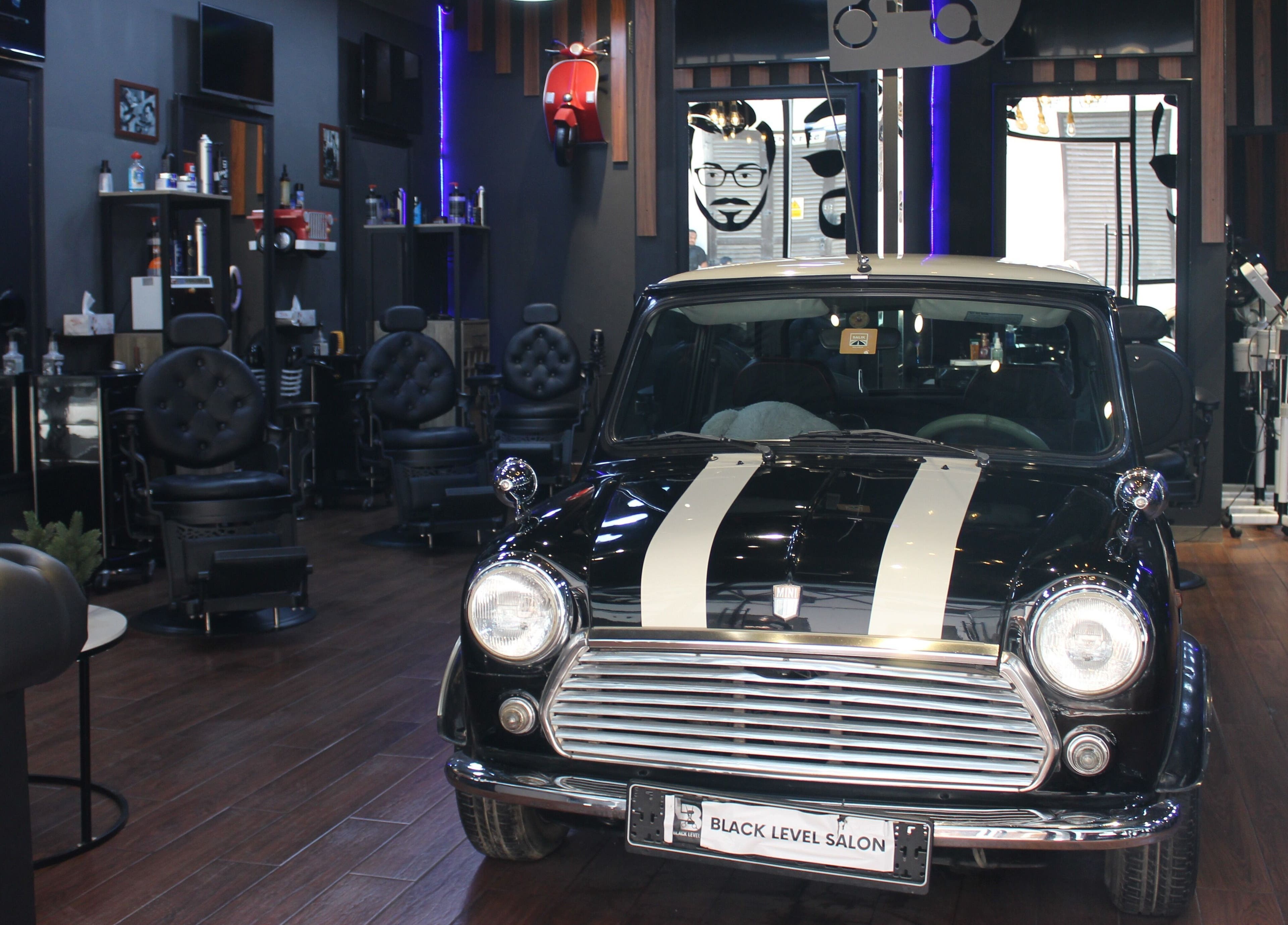 Vintage car inside Black Level Gent's Salon in Dubai, Dubai, AE enhances the stylish barber experience.