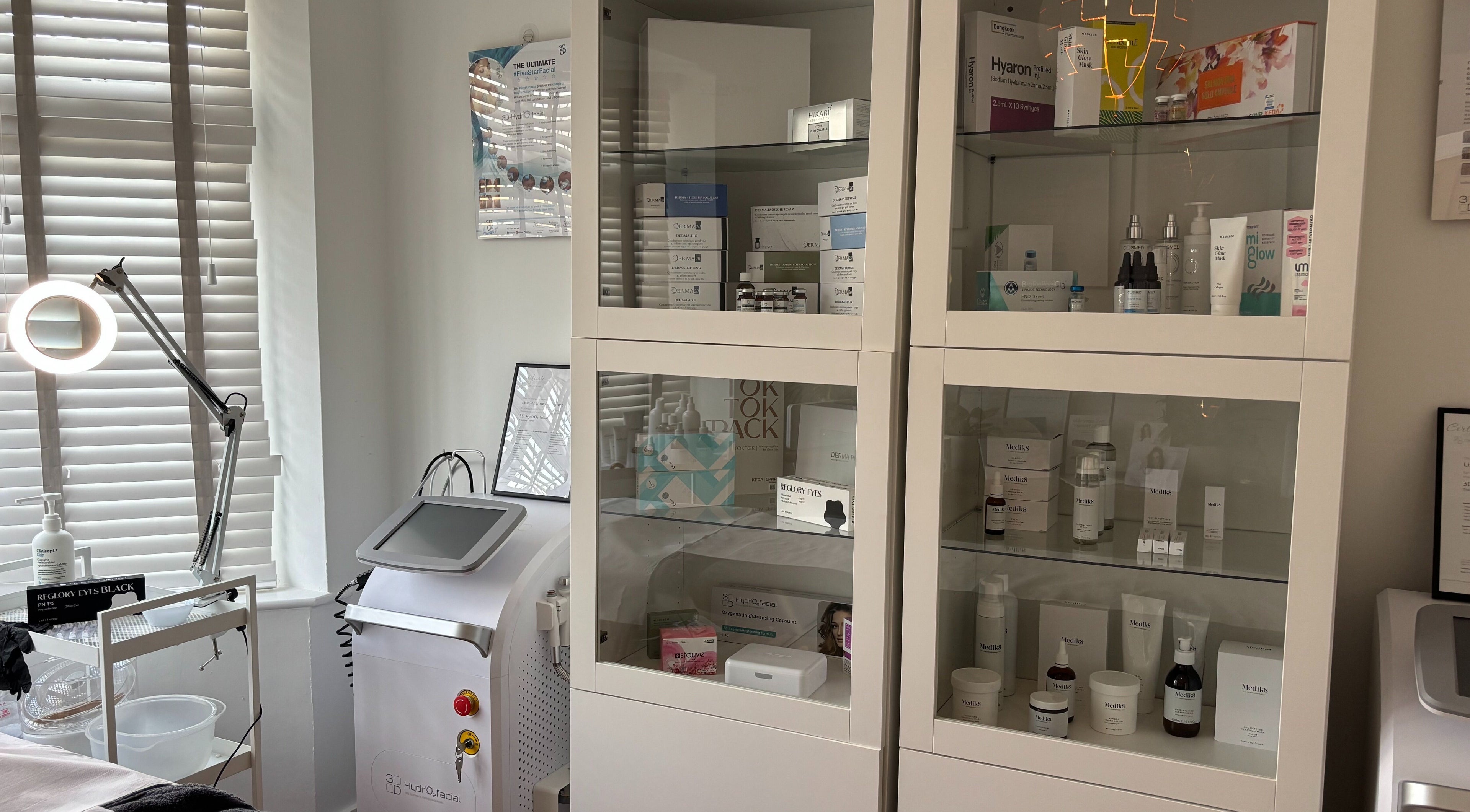 Clean, well-lit treatment room at Skin Within Clinic, Stamford, England, GB showcasing skincare products.