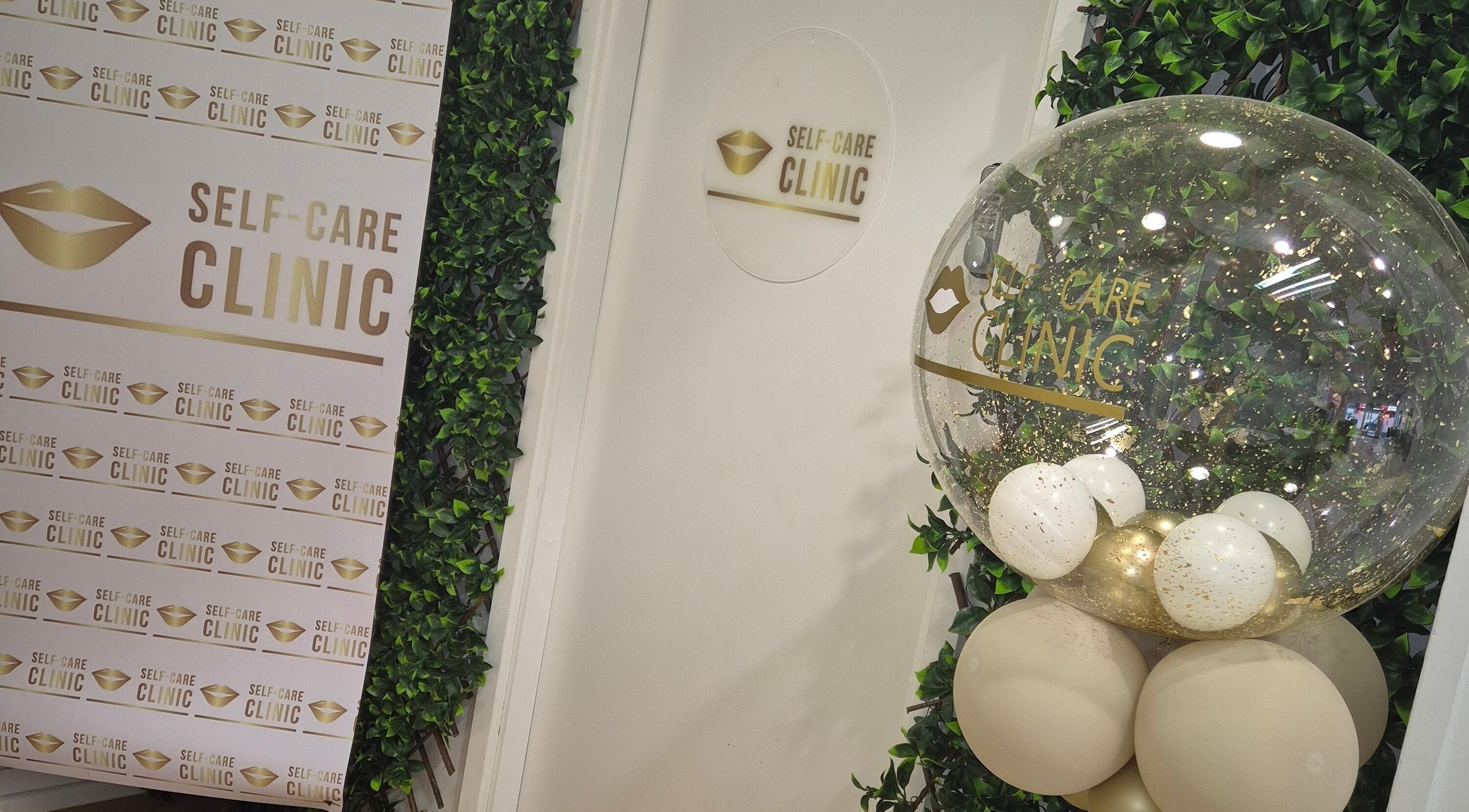 Stylish entrance at Self Care Clinic, Porth, Wales, GB, featuring elegant decor and gold-themed balloons.