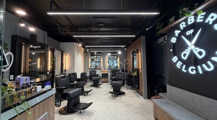 Modern barbershop interior at Barbers Of Belgium Pty Ltd., Southport, QLD, AU, showcasing sleek design and seating.