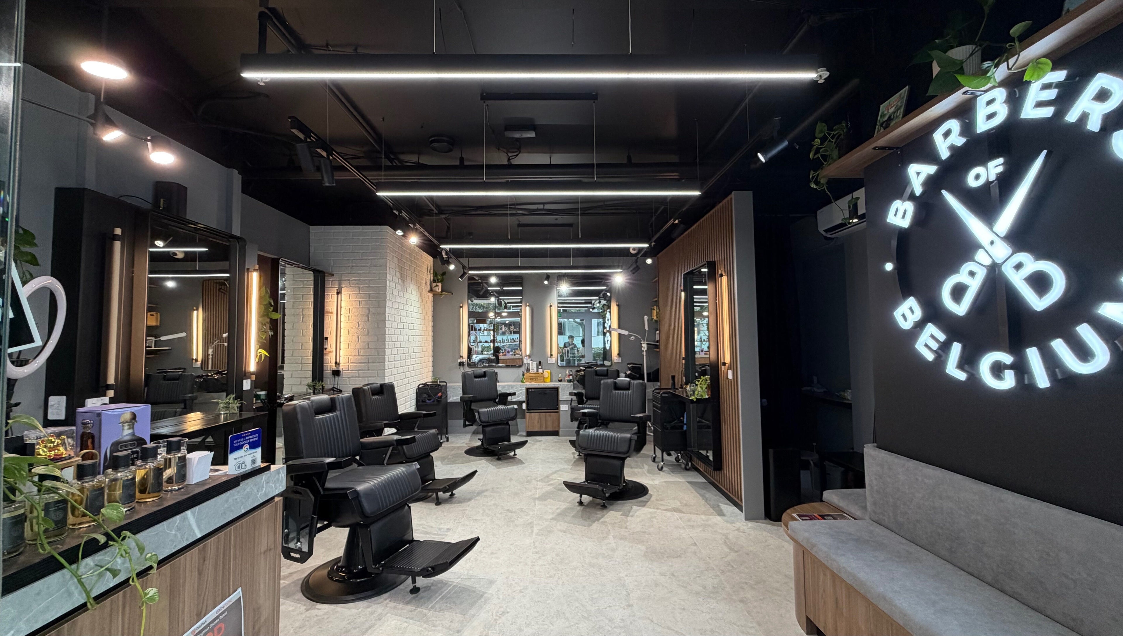 Modern interior of Barbers Of Belgium Pty Ltd. in Southport, QLD, AU featuring sleek black chairs.
