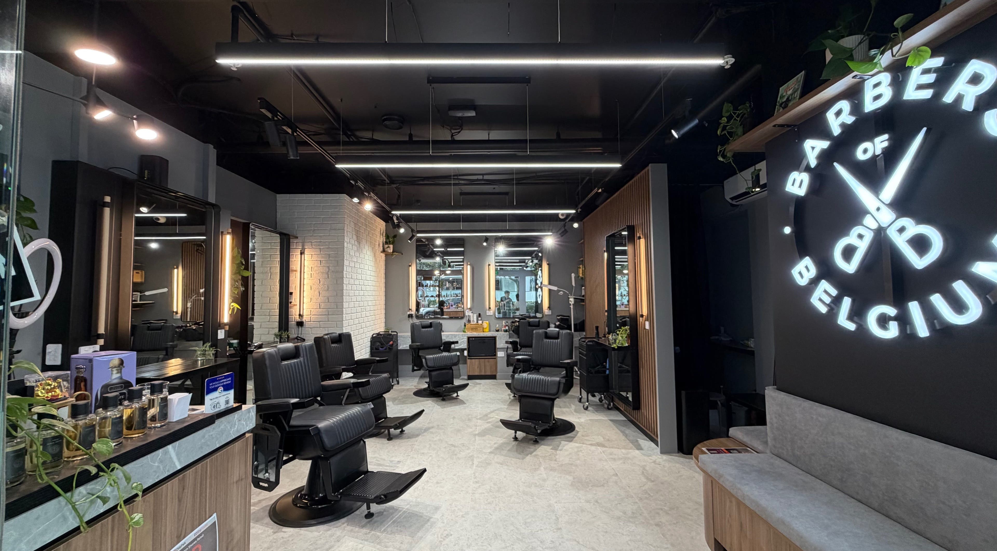 Modern interior of Barbers Of Belgium Pty Ltd. in Southport, QLD, AU featuring sleek black chairs.