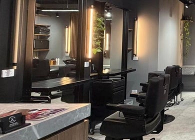 Interior of Barbers Of Belgium Pty Ltd., stylish barbershop in Southport, QLD, AU with sleek seating.