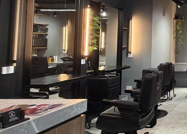 Interior of Barbers Of Belgium Pty Ltd., stylish barbershop in Southport, QLD, AU with sleek seating.