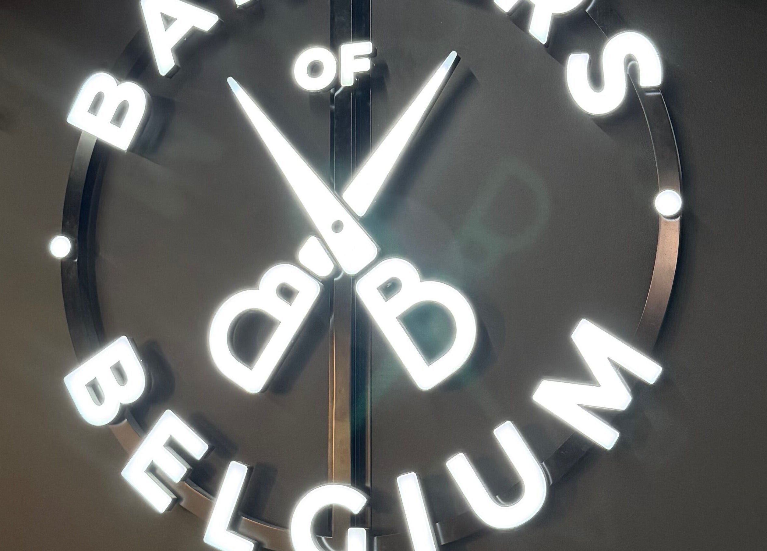 Illuminated logo of Barbers Of Belgium Pty Ltd. at Southport, QLD, AU showcasing scissors in design.