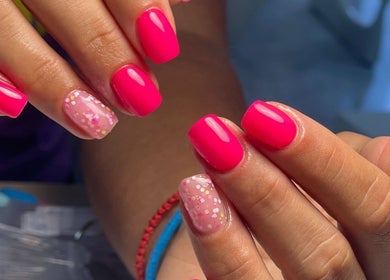 Vibrant pink nails with glitter design at S&M beauty and nails, Qawra, Malta, MT.