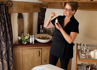 Aesthetician at Ethical Boutique - Organic Skincare Studio in Bury St Edmunds using skincare potion.