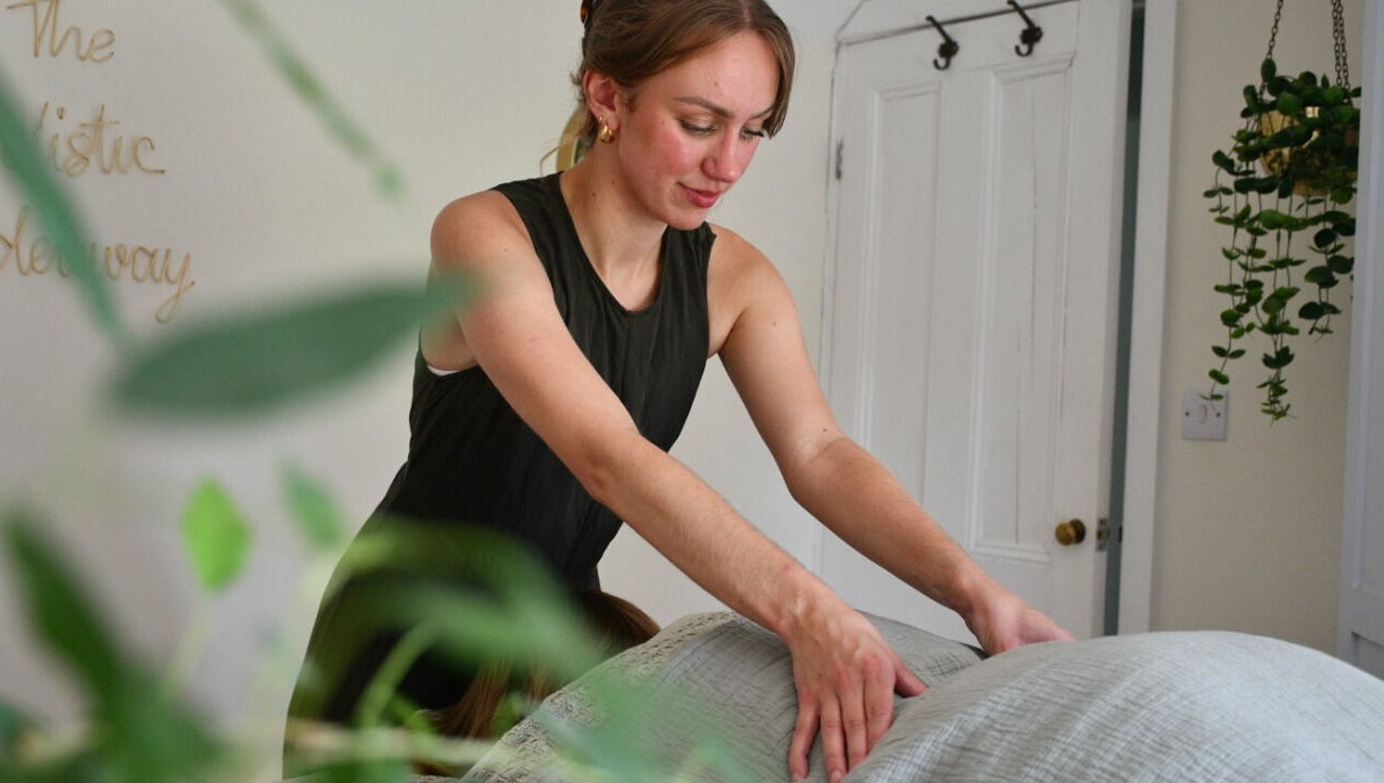 Therapist performs a soothing massage at The Holistic Hideaway in Pott Row, England, GB.