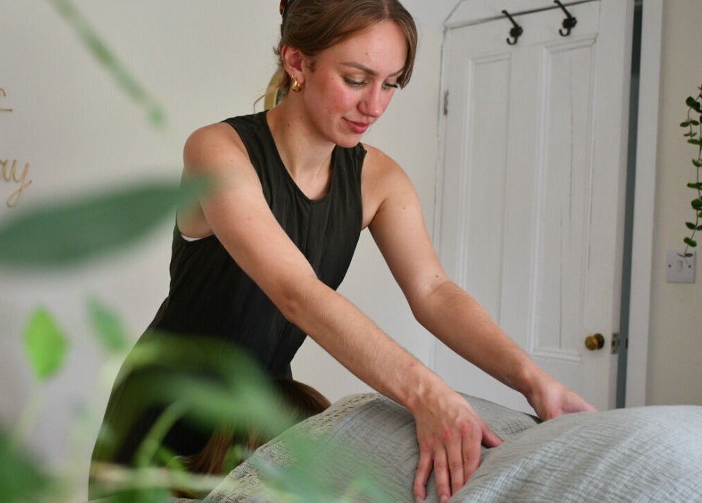 Therapist performs a soothing massage at The Holistic Hideaway in Pott Row, England, GB.