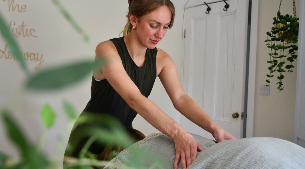 Therapist performs a soothing massage at The Holistic Hideaway in Pott Row, England, GB.