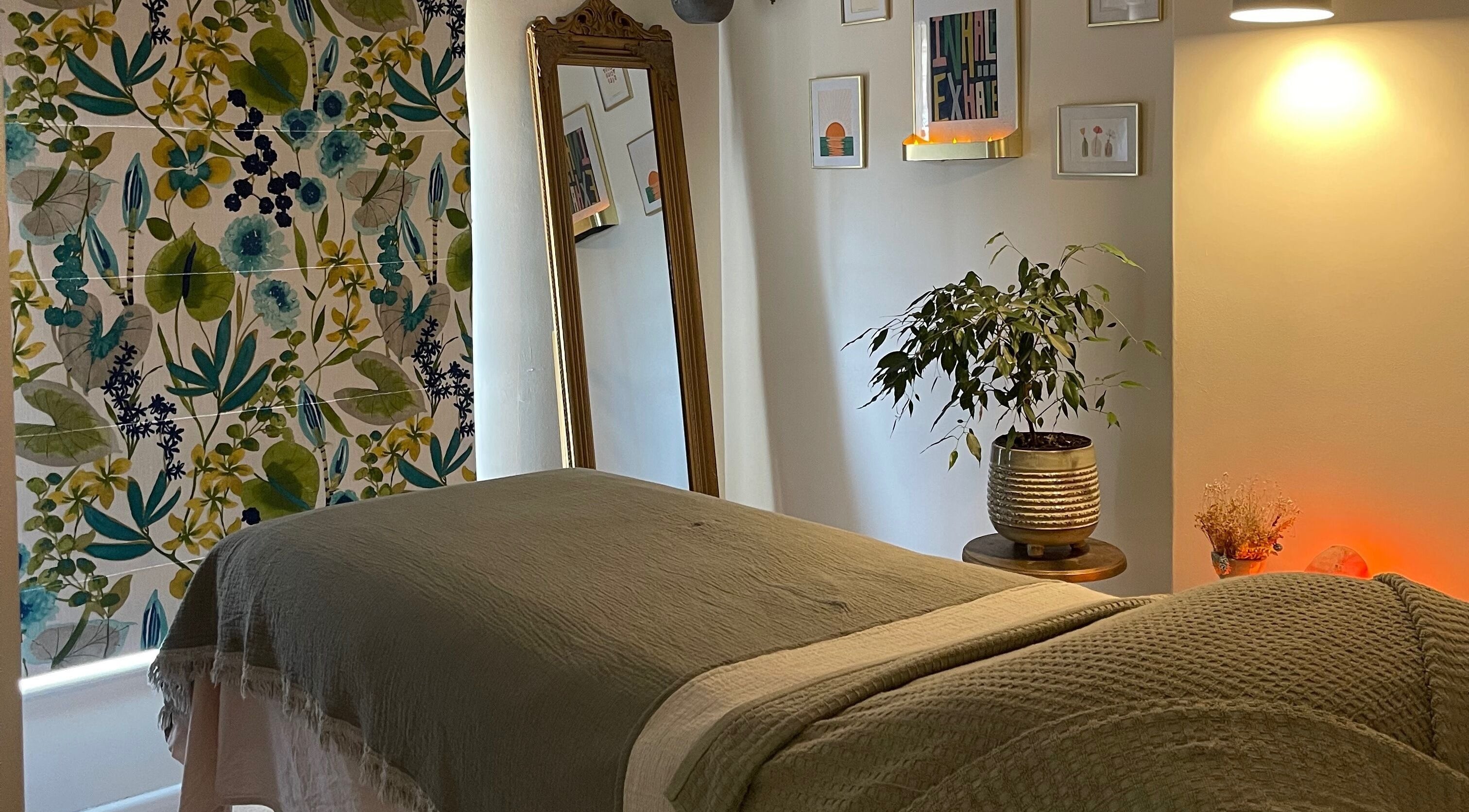 Relaxing treatment room at The Holistic Hideaway, Pott Row, England, GB, featuring calming decor and soft lighting.