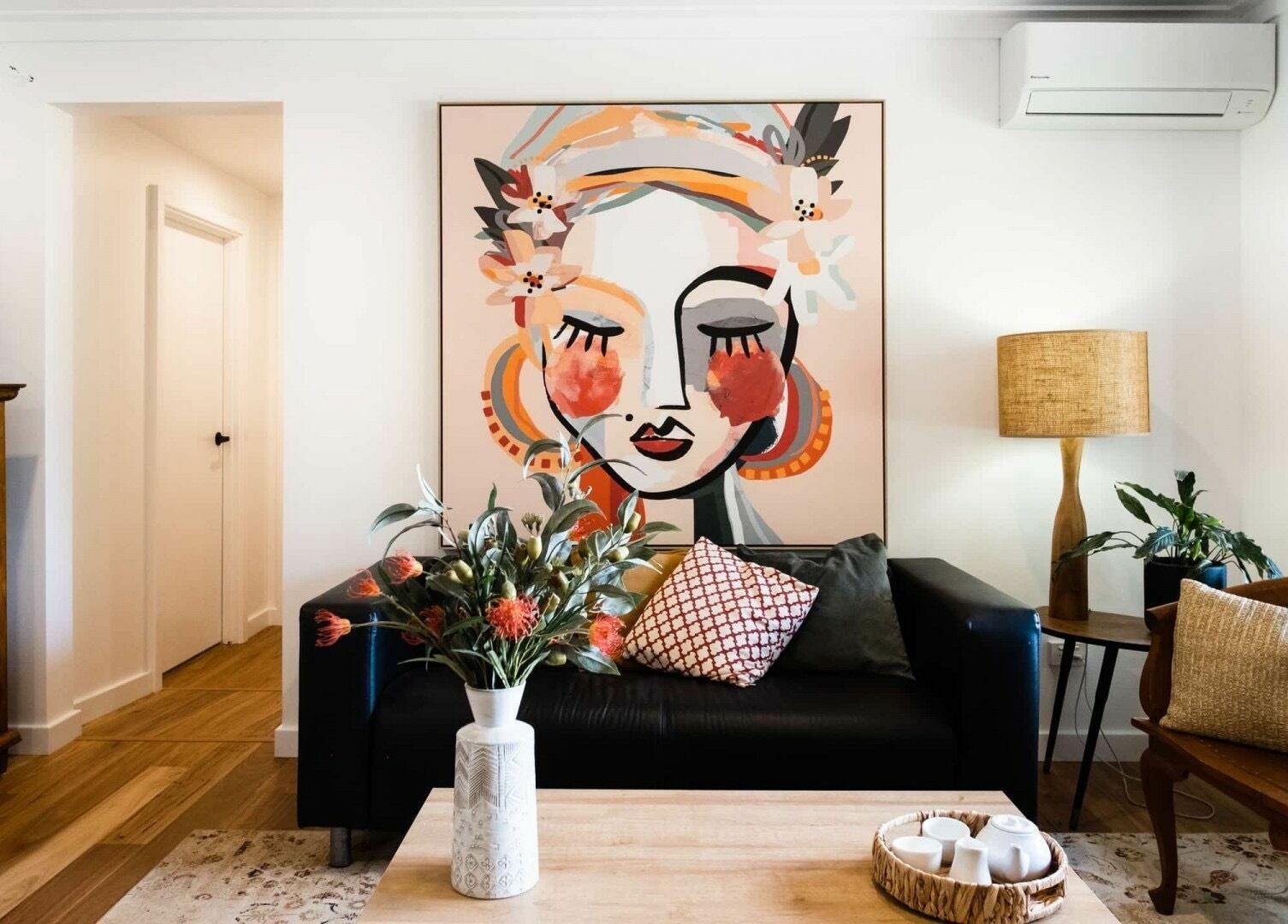 Elegant lounge at Chimes Day Spa in Denmark, Western Australia with vibrant art and cozy decor.