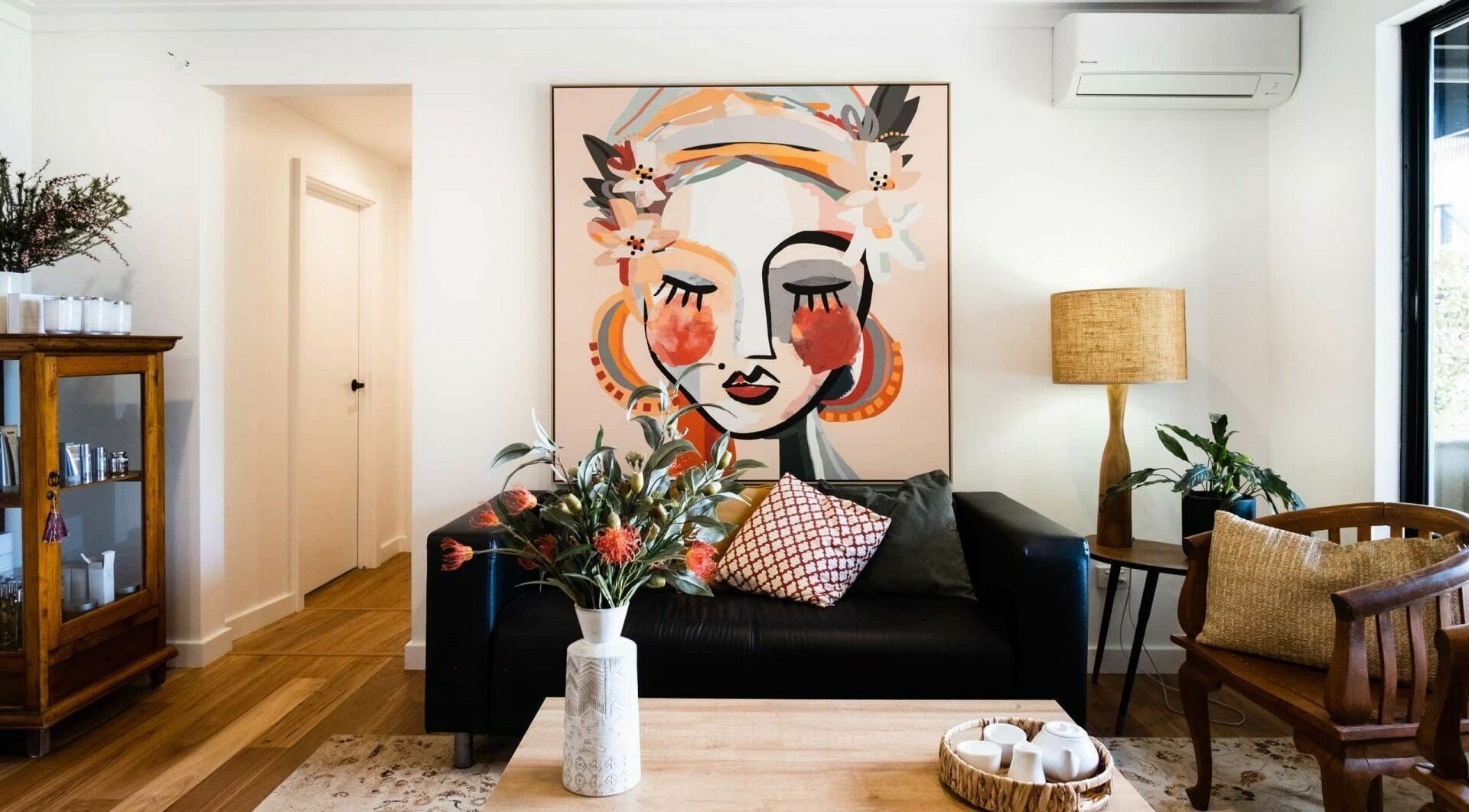 Elegant lounge at Chimes Day Spa in Denmark, Western Australia with vibrant art and cozy decor.