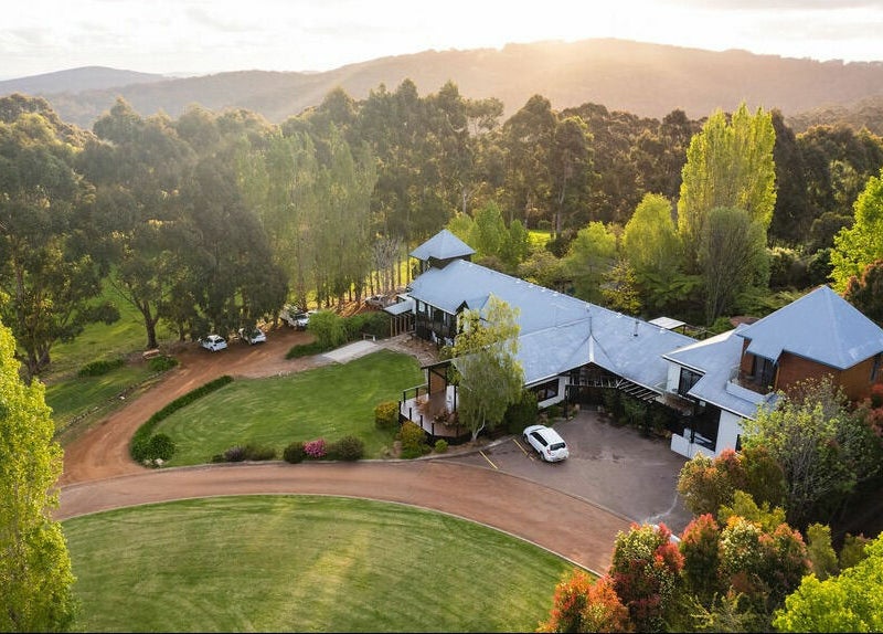 Arial view of Chimes Day Spa amidst lush greenery in Denmark, Western Australia, AU at sunset.