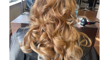 Curly blonde hairstyle at Scarletts Hair in Rochester, England, GB, showcasing salon's styling expertise.
