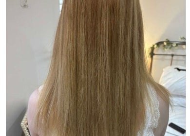 Stylish straight blonde hair at Scarletts Hair, Rochester, England, GB showcasing smooth texture and shine.