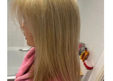 Elegant blonde hairstyle at Scarletts Hair in Rochester, England, GB showcasing smooth and straight hair.