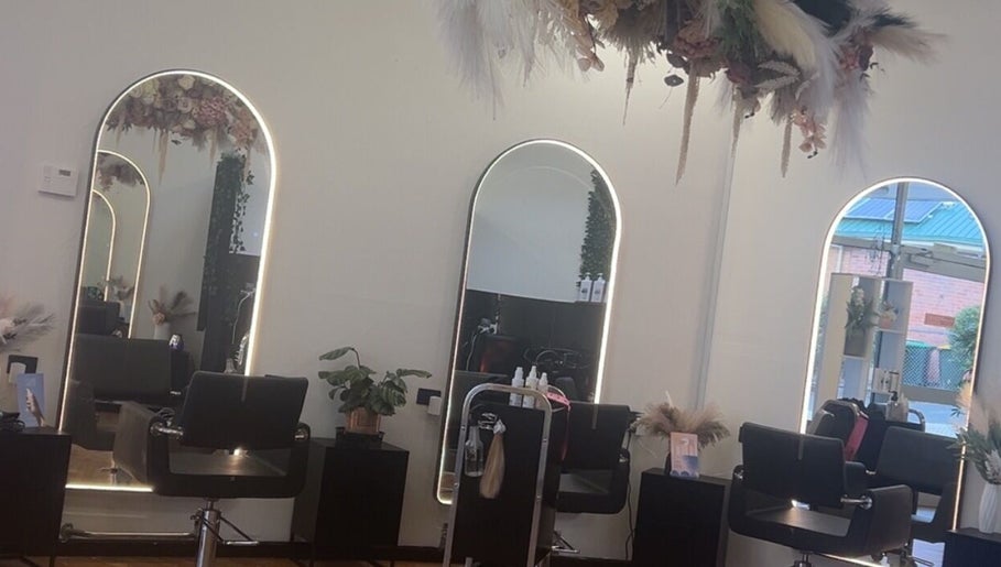 Sleek salon interior at UC Hair, Risdon Vale, Tasmania, AU with stylish mirrors and chairs.