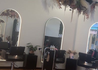 Sleek salon interior at UC Hair, Risdon Vale, Tasmania, AU with stylish mirrors and chairs.