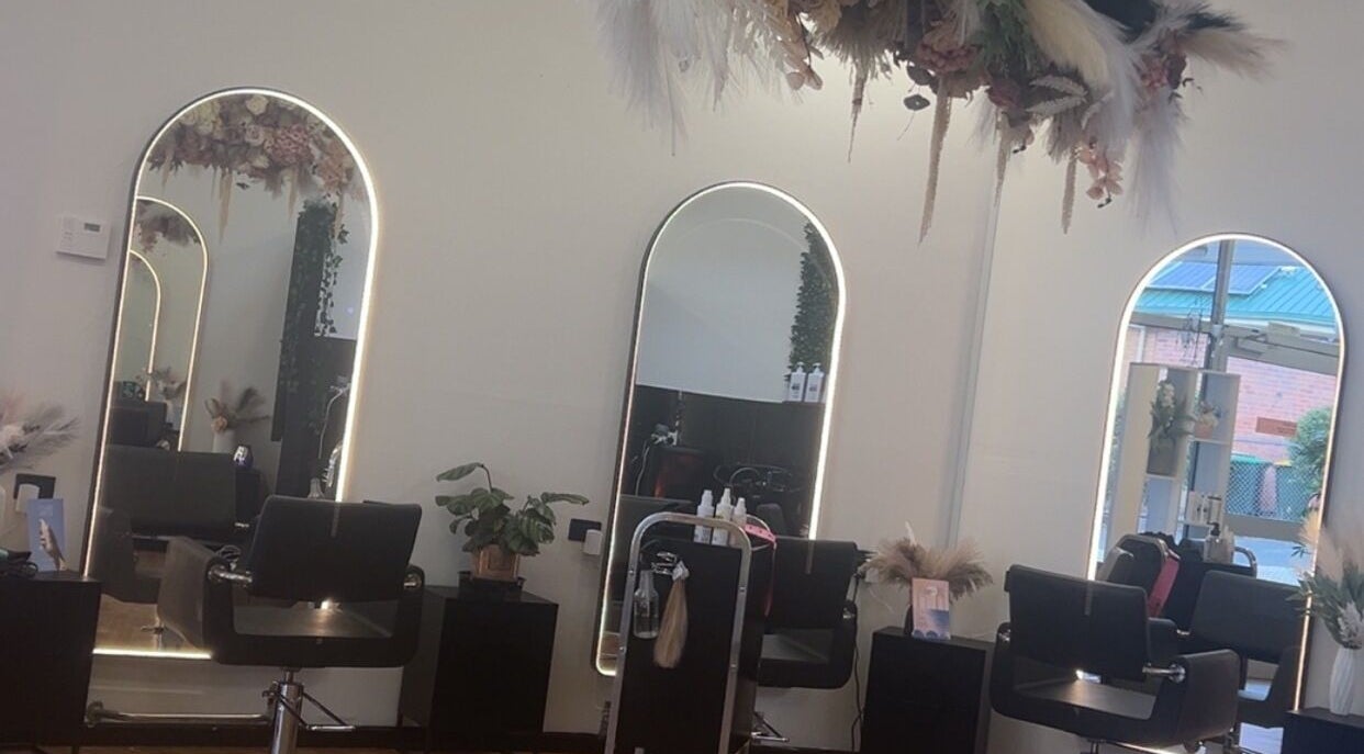 Sleek salon interior at UC Hair, Risdon Vale, Tasmania, AU with stylish mirrors and chairs.
