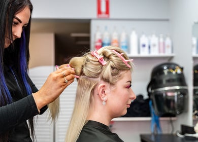 Hairdresser styling client with pink clips at UC Hair, Risdon Vale, Tasmania, AU.
