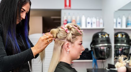 Hairdresser styling client with pink clips at UC Hair, Risdon Vale, Tasmania, AU.