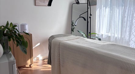 Calming therapy room at Blooming Beauty Co, Mount Nasura, Western Australia, AU, with a massage table and plants.