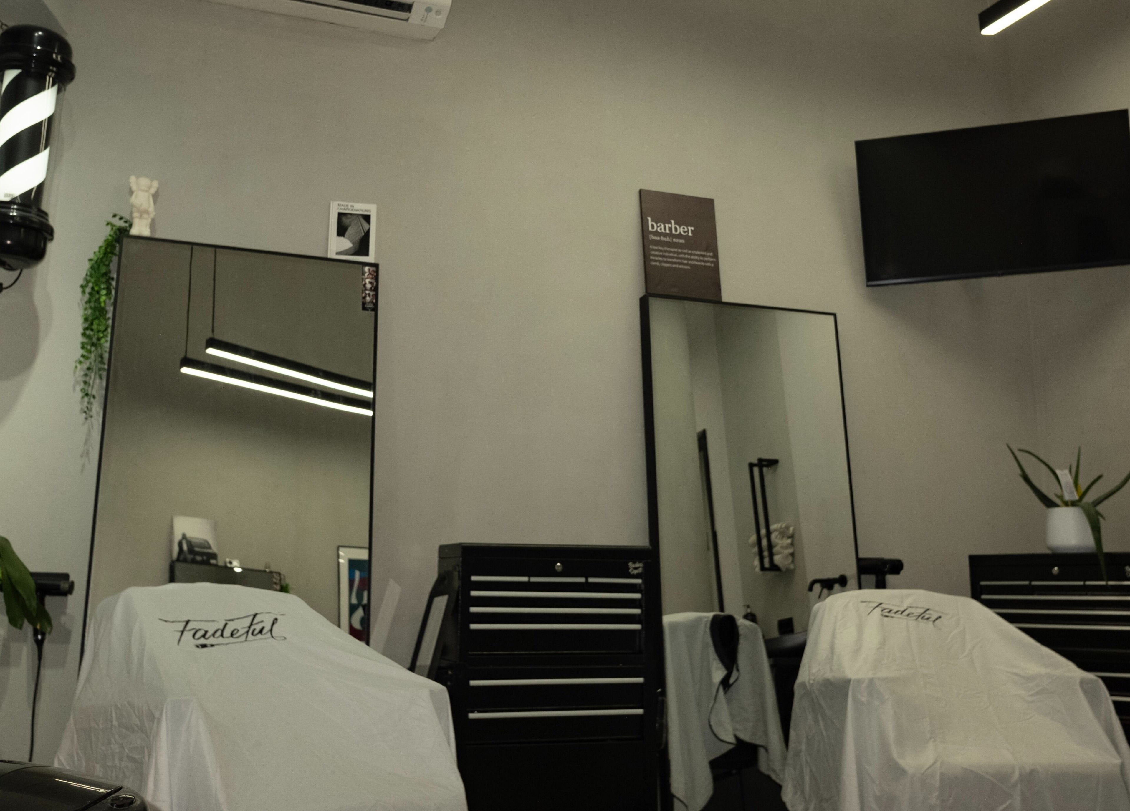 Interior of Fadeful Barbershop in Almere, Flevoland, NL with modern mirrors and barber chairs.