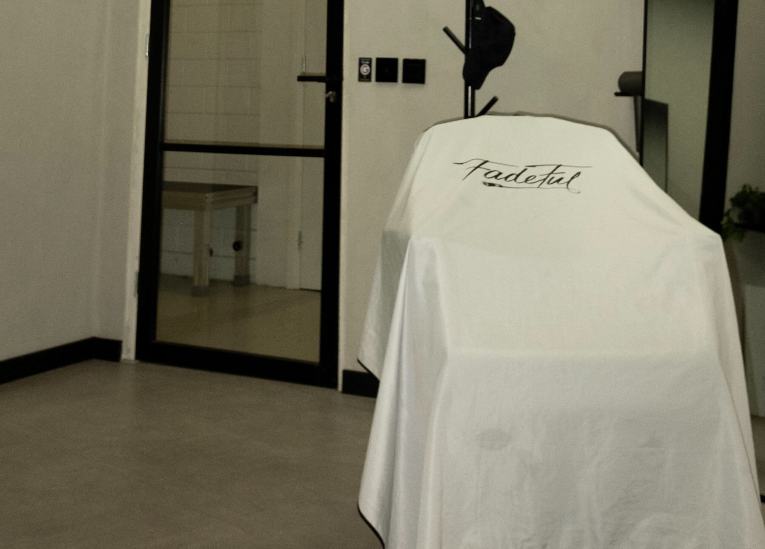 Interior of Fadeful Barbershop in Almere, Flevoland, NL featuring a covered barber chair.