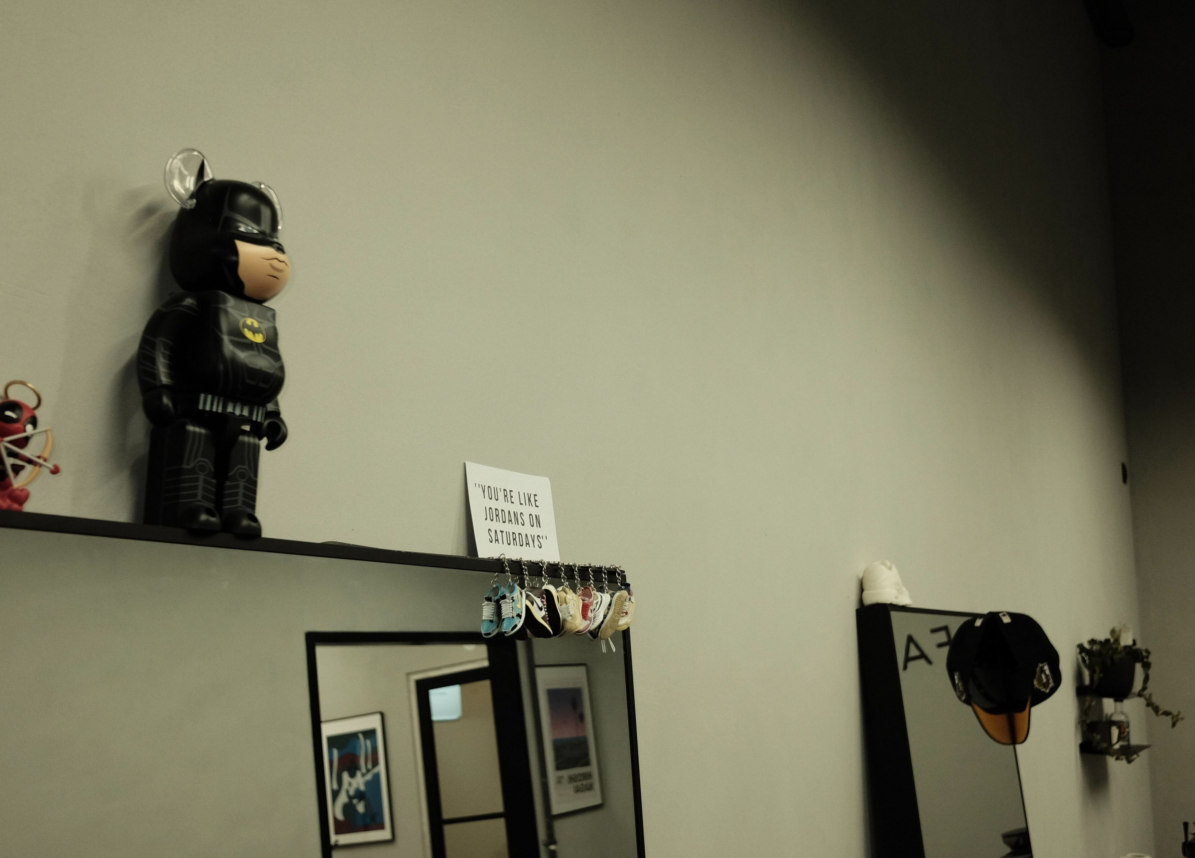Shelf with figurines and decor at Fadeful Barbershop, Almere, Flevoland, NL.