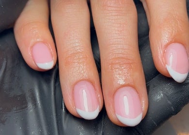 Elegant French manicure at Nics Nails, Shrewsbury, England, GB, showcasing glossy pink nails with white tips.