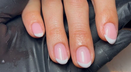 Elegant French manicure at Nics Nails, Shrewsbury, England, GB, showcasing glossy pink nails with white tips.