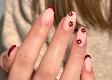 Nail art with red flowers at Nics Nails in Shrewsbury, England, GB, showcasing elegant beauty and style.