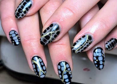 Close-up of intricate black and white nail art at Nics Nails, Shrewsbury, England, GB.