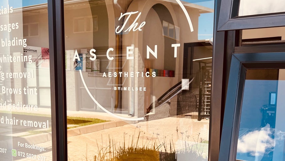 Front window at The Ascent Aesthetics in Midrand, Gauteng, ZA, showcasing beauty services in modern lettering.
