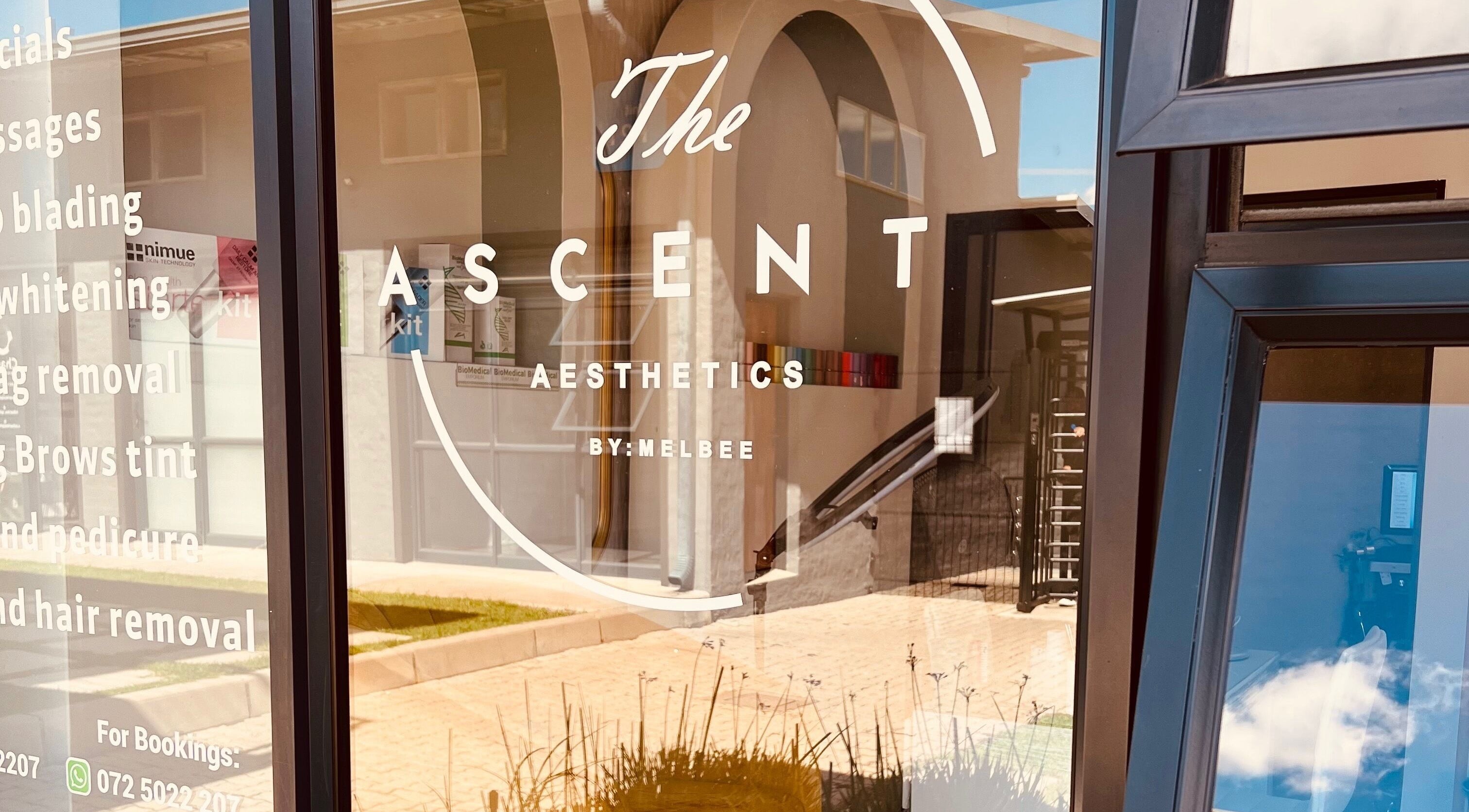 Front window at The Ascent Aesthetics in Midrand, Gauteng, ZA, showcasing beauty services in modern lettering.